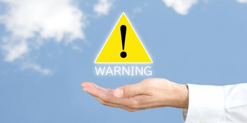 手のひらの上に「WARNING」と警告マーク