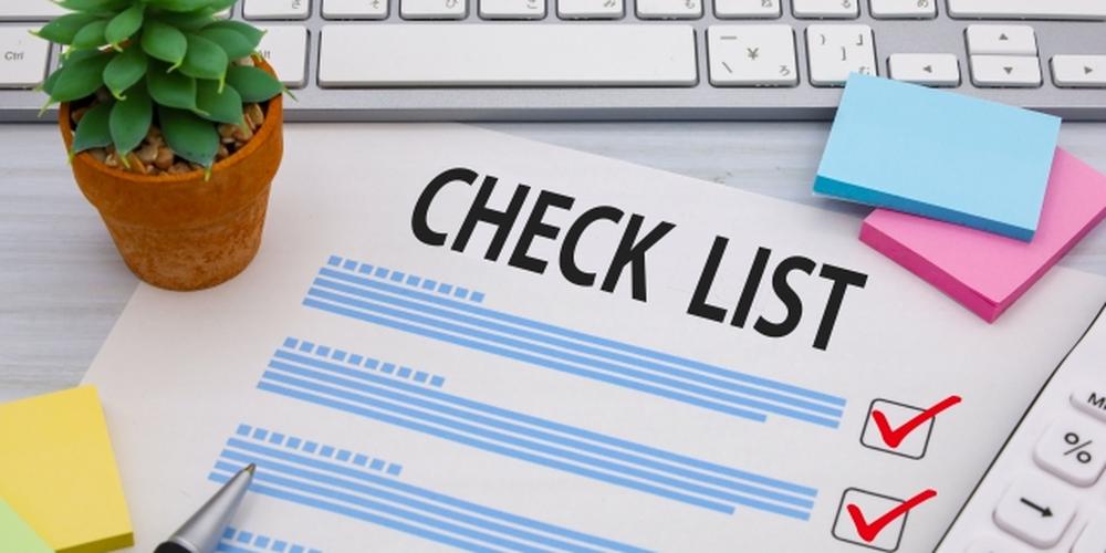 「CHECK LIST」と書かれた用紙にチェックマークが入り、付箋・観葉植物・キーボードが並ぶ